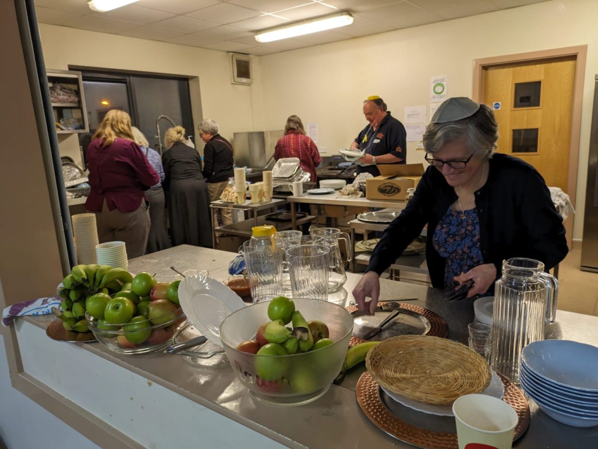 Rabbi Dr Margaret Jacobi helps with the post-Iftar clearing up