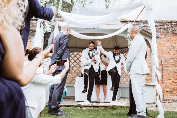 The couple break the glass in a ceremony that combined their two traditions