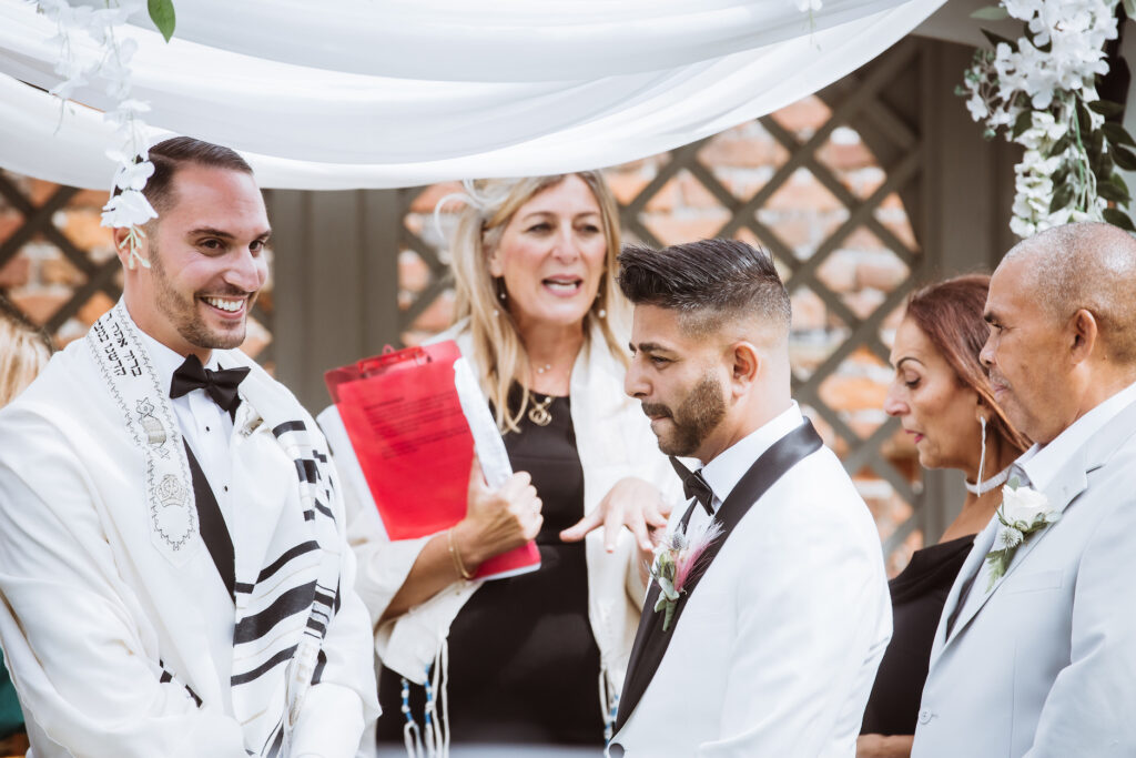 Adam and Ali under the Chuppah with Rabbi Rebecca Birk